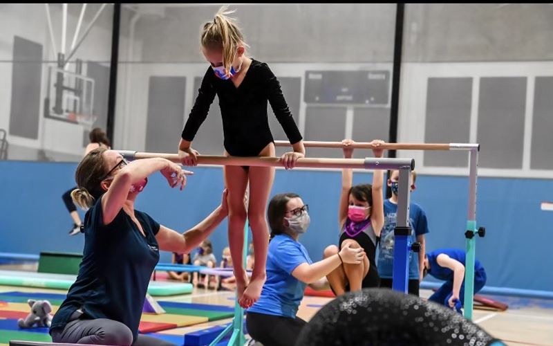 Image of little girl in a gymnastics bar